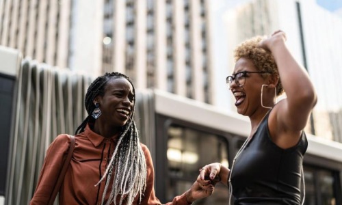 women laughing together in the city