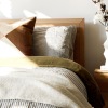 a bedroom with a nightstand and a  dresser